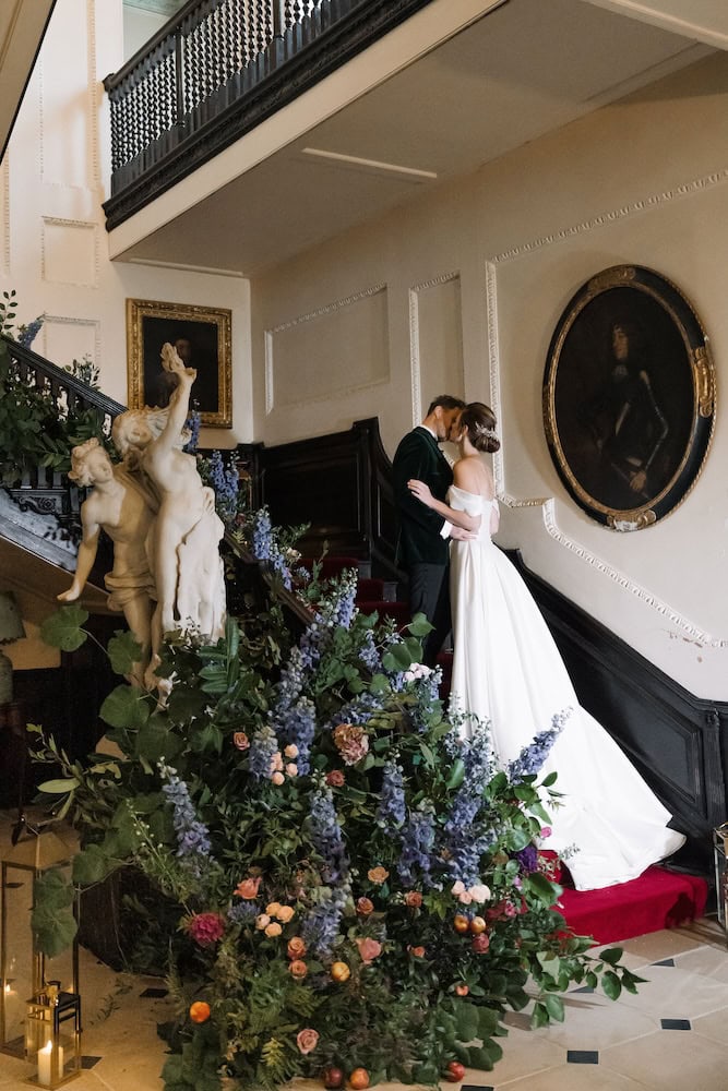 Bride And Groom On Floral Staircase At Pylewell Park