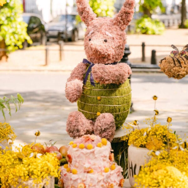 piglet floral installation with pink cake and floral honey pot
