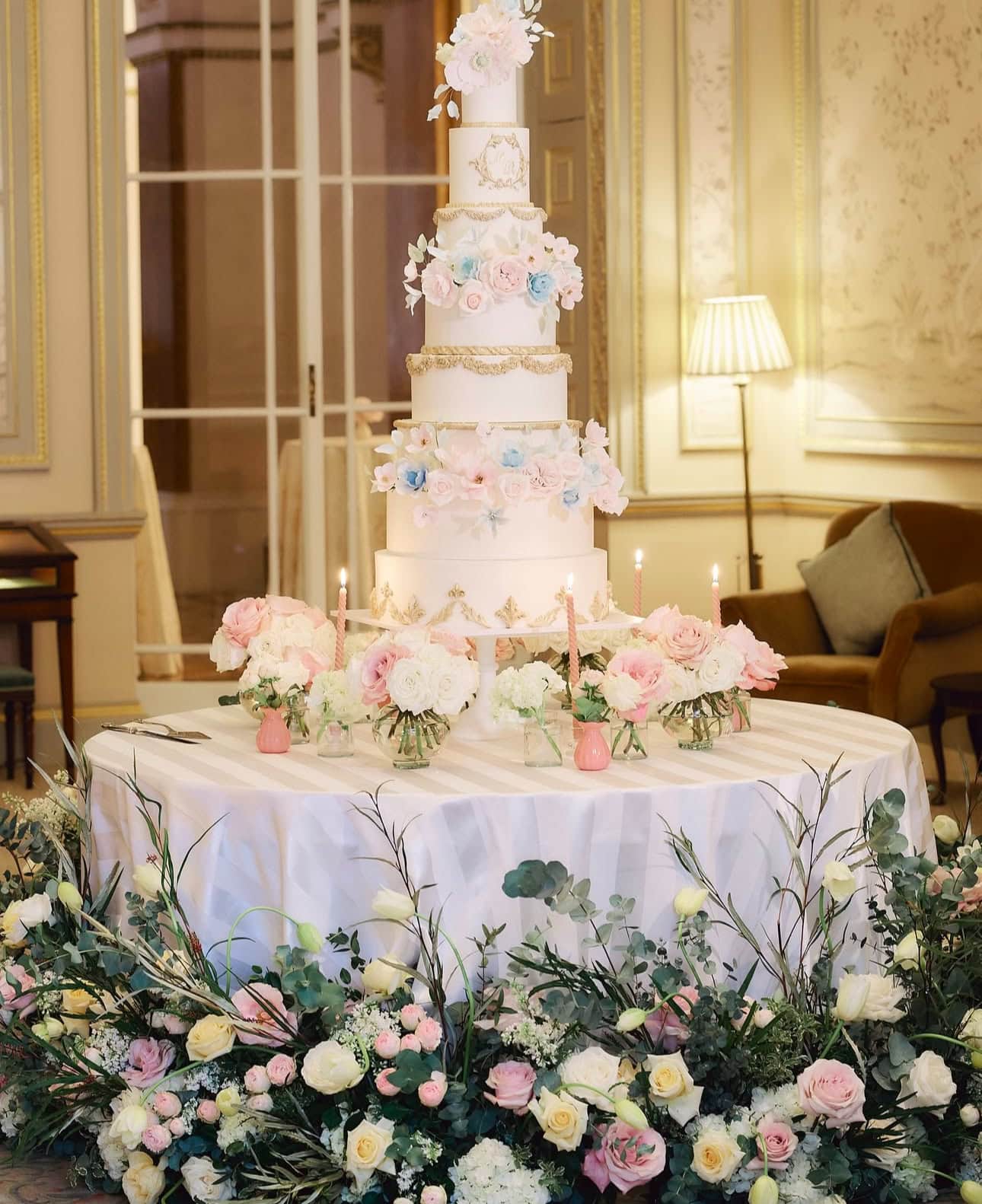 Floral installation for a wedding cake table at The Lansdowne Club featuring growing French tulips, white lilac, bombastic spray roses, Sweet Avalanche roses in pink and cream, white Columbia hydrangea, and layered eucalyptus and olive foliage for a wild, dramatic look.