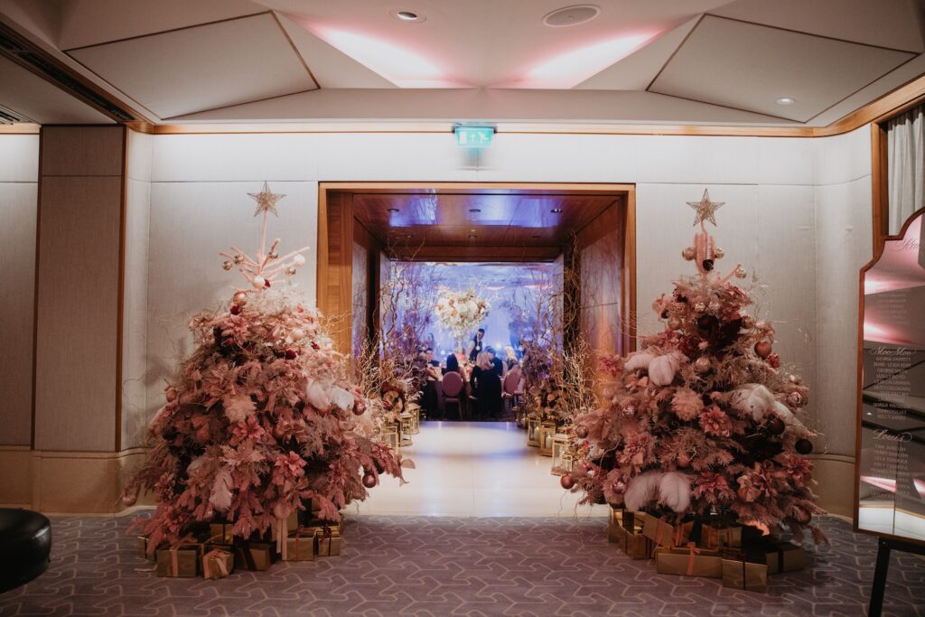 Pink Christmas Trees Framing Wedding Reception Entrance