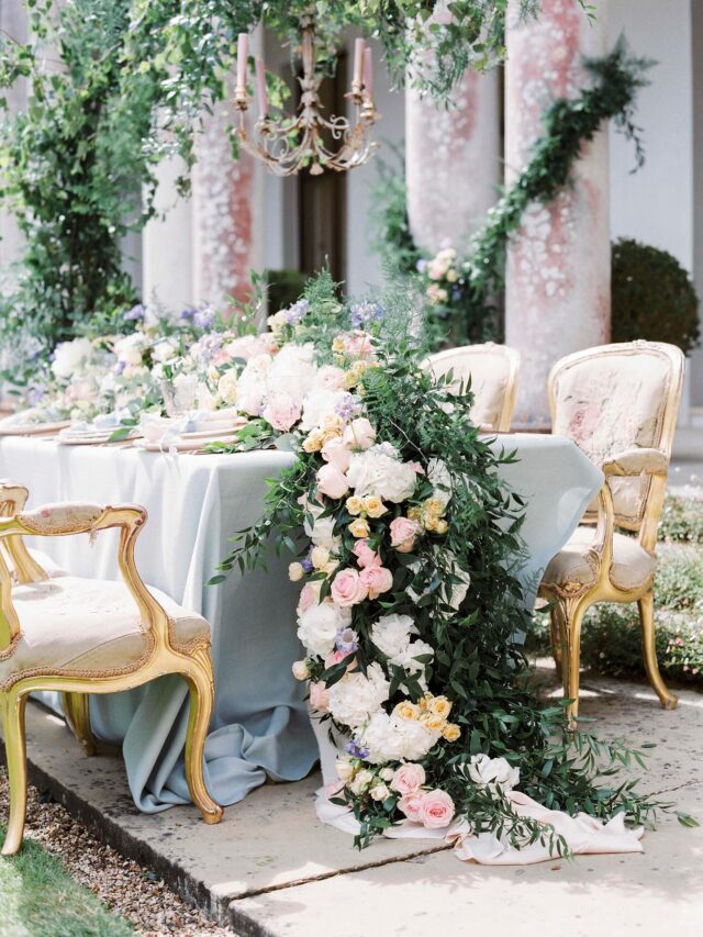 Stunning tablescape brought to life with cascading pastel florals, soft textures, and flowing greenery.