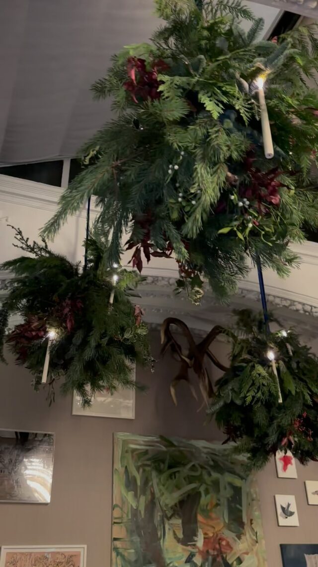 Creating a festive wonderland with hanging pine explosions, opulent blue ribbons, and floating candles that light up the season.