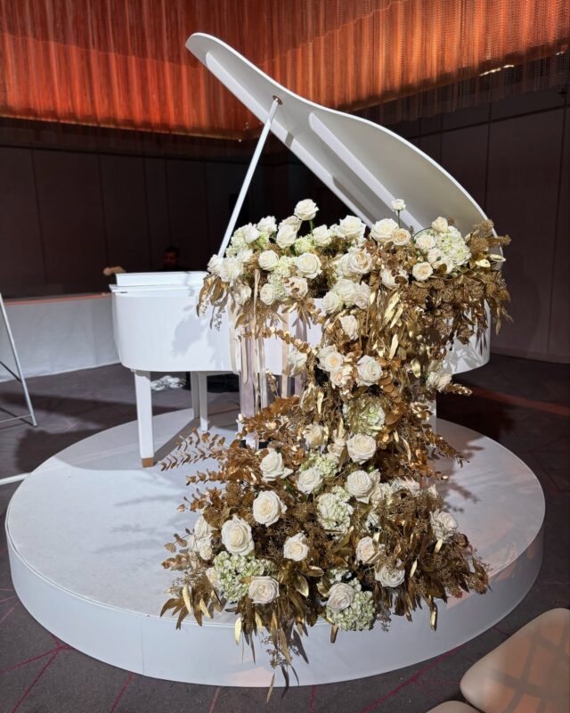 Elegance in every note : A cascading display of white hydrangeas, Playa Blanca roses, and gold eucalyptus.